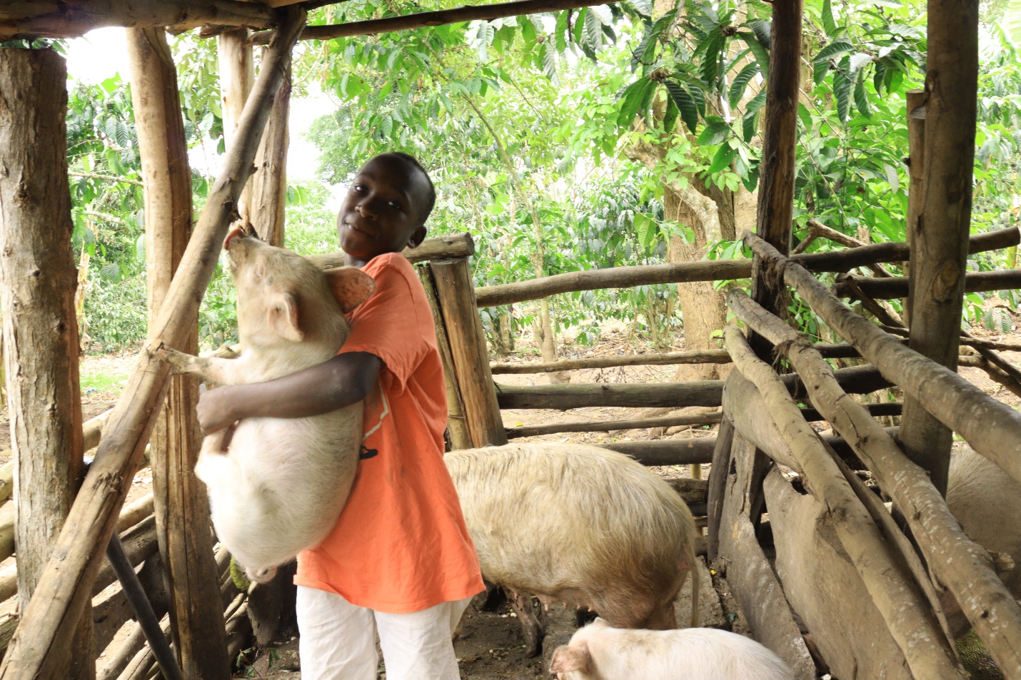 Kayanja Samuel with his piglet